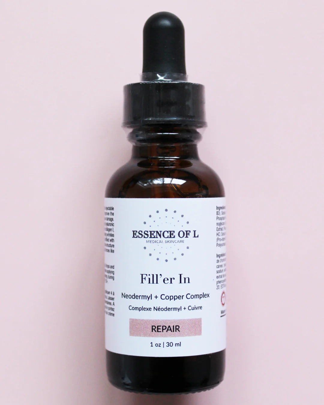 The image shows a brown glass dropper bottle of face serum. The bottle has a black dropper top and a white label with the following text:
ESSENCE OF L MEDICAL SKINCARE
Fill'er In
Neodermyl + Copper Complex
Complexe Néodermyl + Cuivre
REPAIR
1 oz | 30 ml