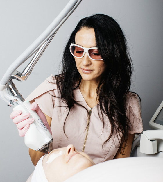 A woman in a pink (Leah) is serving a customer , showcasing a focused and glamorous beauty routine.