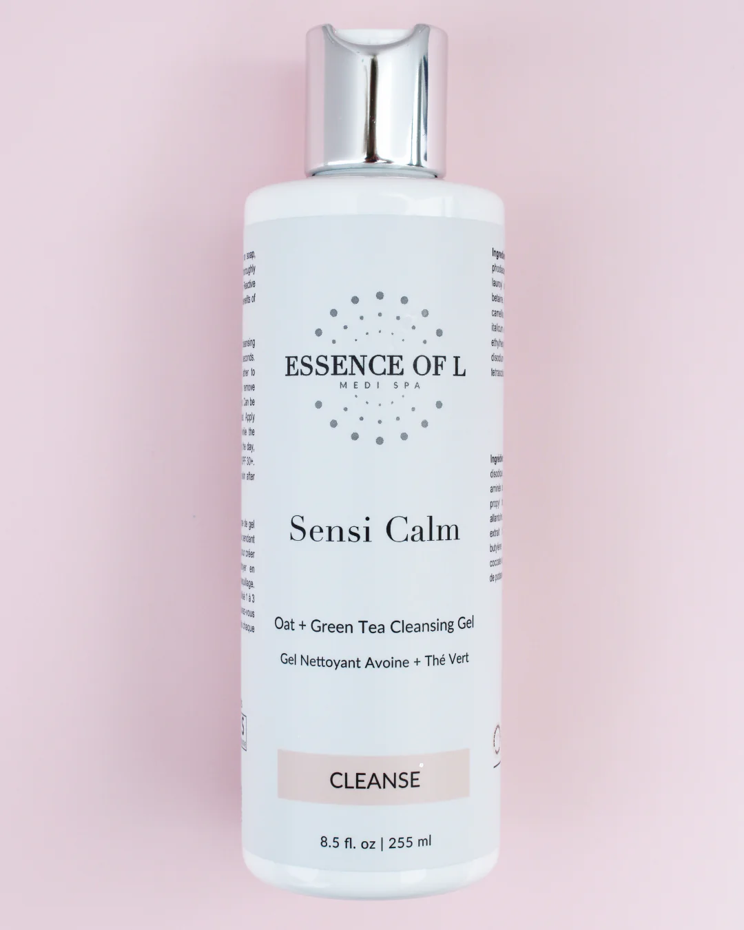 The image shows a white bottle of facial cleanser. The bottle has a silver pump top and a white label with the following text:
ESSENCE OF L MEDI SPA